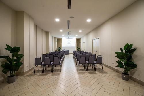 a room with a row of chairs in a hall at Grand Hotel Villa Itria Congress & Spa in Viagrande