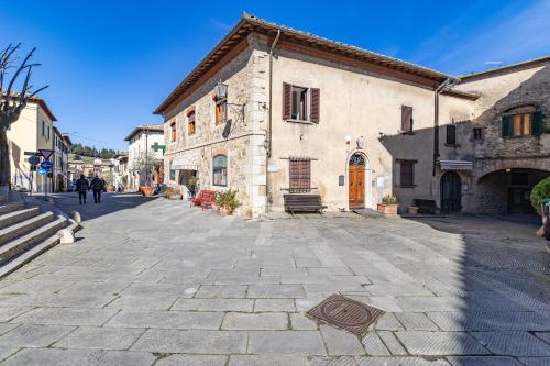 a cobblestone street in a town with a building at Chianti Classico Home Panoramic View - Happy Rentals in Castellina in Chianti