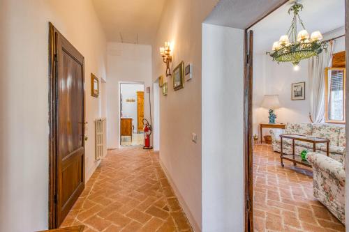 a hallway with a door and a living room at Chianti Classico Home Panoramic View - Happy Rentals in Castellina in Chianti
