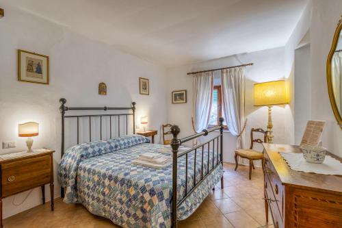 a bedroom with a bed and a desk at Chianti Classico Home Panoramic View - Happy Rentals in Castellina in Chianti