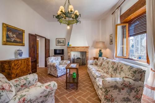 a living room with couches and a fireplace at Chianti Classico Home Panoramic View - Happy Rentals in Castellina in Chianti