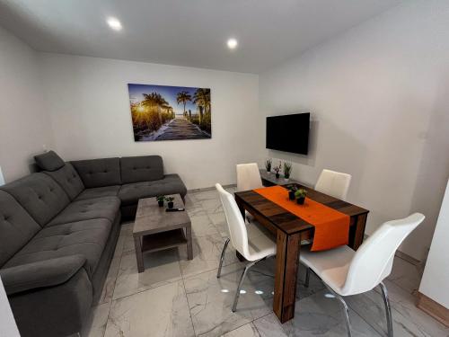 a living room with a couch and a table at Apartment Mandy in Rečica ob Savinji