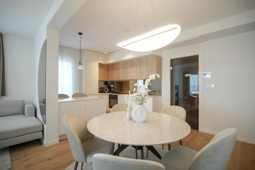 a dining room and kitchen with a table and chairs at Adria Concept Suites in Zadar