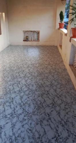an empty room with a tile floor with a fireplace at Om Laxmi Narayan Homestay in Diveagar