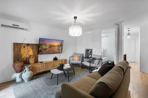 a living room with a couch and a table at 3br unit Stylish retreat SouthPerth in Perth