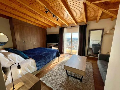 a bedroom with a large bed and a living room at Deluxe Apartment With Sea View in Athens