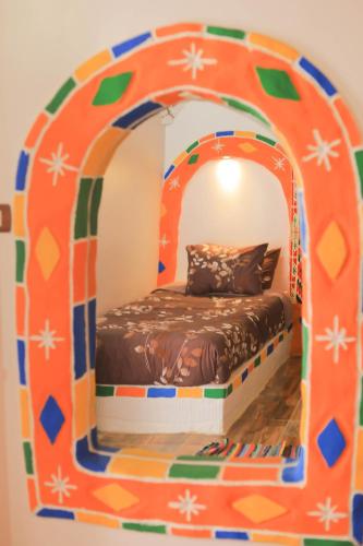 a bed in an igloo in a room at Old Nubian guest house in Aswan