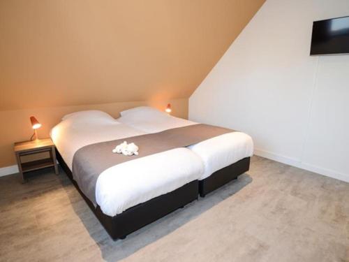 Postel nebo postele na pokoji v ubytování Roggesloot