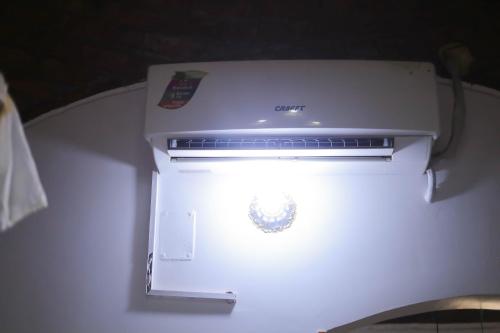 a white refrigerator with a light inside of it at Old Nubian guest house in Aswan