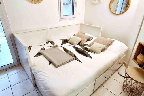 - un lit blanc avec des oreillers dans l'établissement Boulouris - Appt 3/4 pers. bord de mer / piscine, à Saint-Raphaël