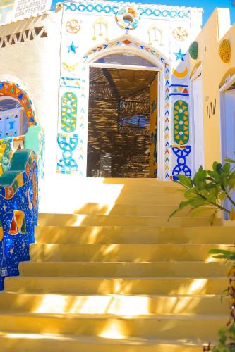 a set of stairs in front of a building with a door at Old Nubian guest house in Aswan