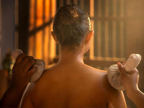 a woman holding two hair dryers at Ragamaya Resort & Spa Munnar in Munnar