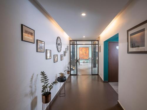 a hallway of a home with a clock on the wall at Ragamaya Resort & Spa Munnar in Munnar