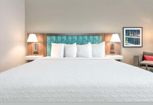 a large white bed in a hotel room at Hampton Inn & Suites Dallas-Allen in Allen