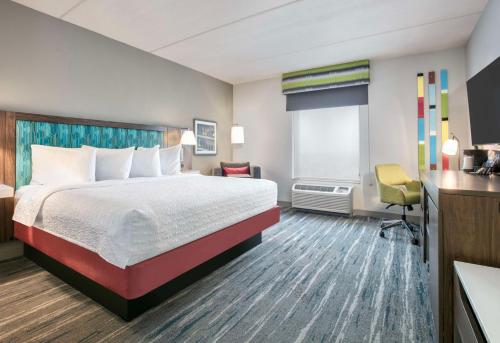 a hotel room with a bed and a desk at Hampton Inn & Suites Dallas-Allen in Allen