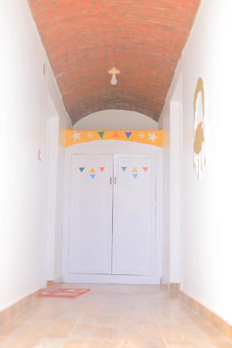 a room with white walls and a ceiling at Old Nubian guest house in Aswan