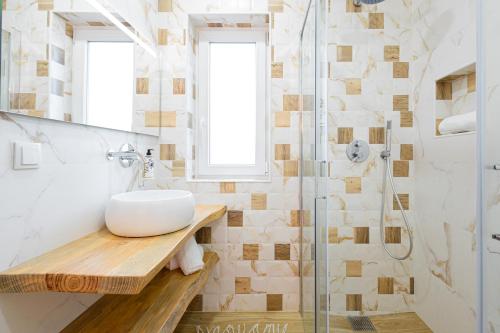 a bathroom with a sink and a shower at Monte do Cerro in Porto Covo