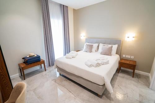 a bedroom with a large bed with towels on it at L-Eremita Boutique Hotel in Qala