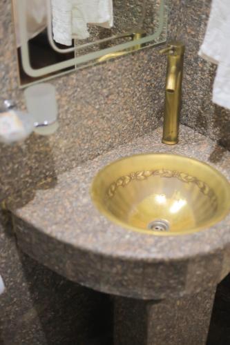 a sink in a bathroom with a gold sink at Old Nubian guest house in Aswan