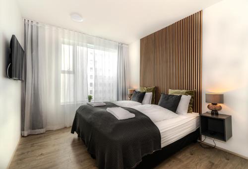 Postel nebo postele na pokoji v ubytování Sif Apartments by Heimaleiga