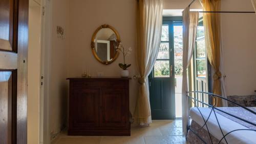 a bedroom with a mirror and a dresser and a bed at Villa Il Casale Onifai- piano terra in Onifai