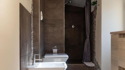 a bathroom with a toilet and a sink and a shower at Villa Il Casale Onifai- piano terra in Onifai