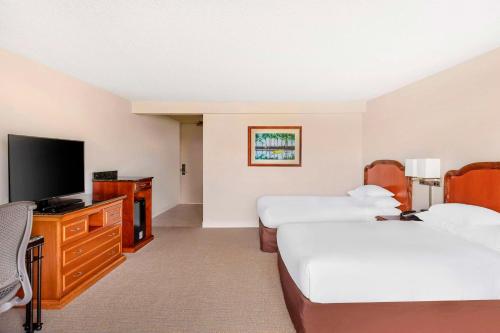 a hotel room with two beds and a flat screen tv at Hilton Grand Vacations Club Ocean Tower Waikoloa Village in Waikoloa