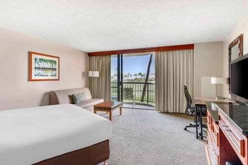 a hotel room with a bed and a balcony at Hilton Grand Vacations Club Ocean Tower Waikoloa Village in Waikoloa