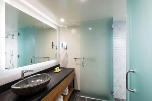 a bathroom with a sink and a mirror at Hilton Grand Vacations Club Ocean Tower Waikoloa Village in Waikoloa