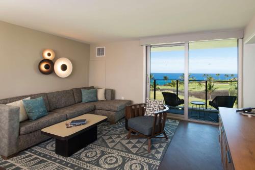 a living room with a couch and a table at Hilton Grand Vacations Club Ocean Tower Waikoloa Village in Waikoloa