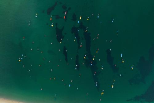 a group of people standing in the water at night at Hawthorn Suites by Wyndham Dwarka in Dwarka