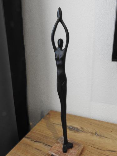 a statue of a woman doing a yoga pose on a table at Ferienwohnungen am Hauptplatz in Pirna