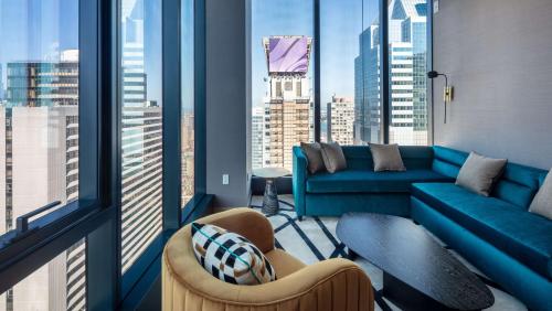 a living room with a view of a city at Tempo By Hilton New York Times Square in New York
