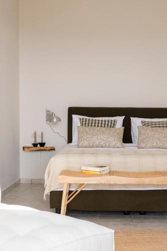 a bedroom with a large bed and a table at Ursa Minor in Mousata