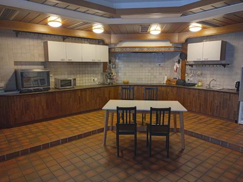 a large kitchen with a table and chairs in it at St Maximin Erdgeschoß Lounge in Trier