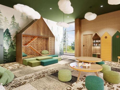 a room with a fireplace and a table and chairs at Mercure Szczyrk Resort in Szczyrk