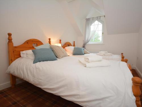 a bedroom with a large white bed with pillows at 2 Bed in Cosheston 60704 in Cosheston