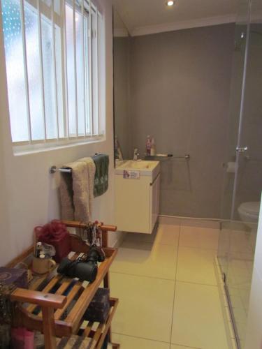 a bathroom with a shower and a sink and a toilet at Victorian Woodstock in Cape Town