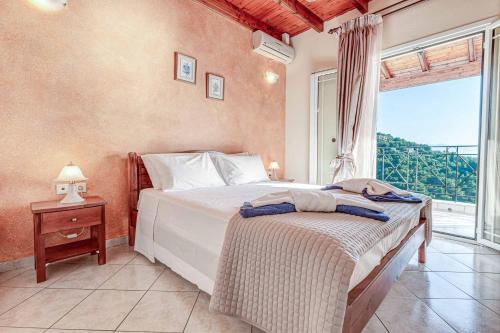 a bedroom with a bed and a large window at Villa Agni Sea View in Agní