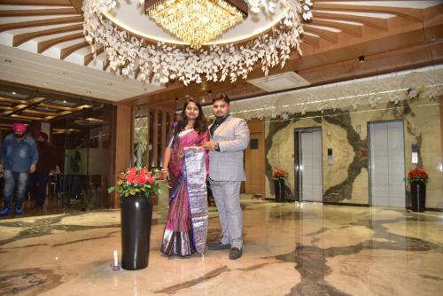 a man and a woman posing for a picture in a lobby at BANMALI REGENCY in Jamshedpur