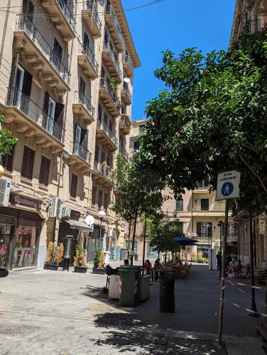an empty street in a city with buildings at B&B Villareale 35 in Palermo
