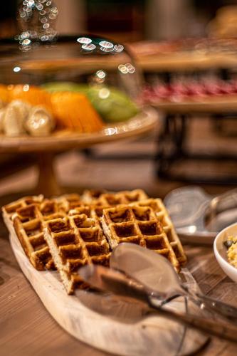 a plate with waffles on top of a table at Hameau Mukhrani in Mukhrani