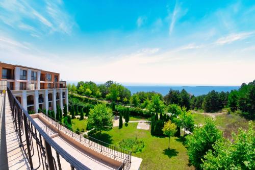 a balcony of a building with a garden at Sea Fort Club Complex in Sveti Vlas