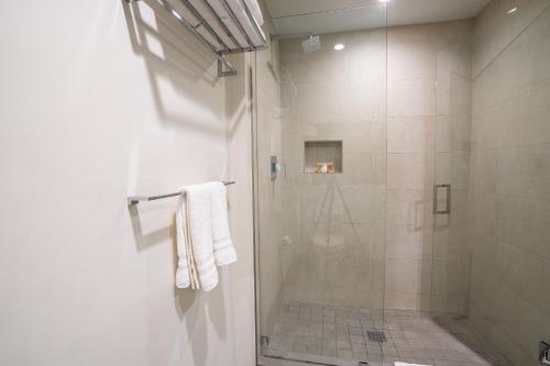 a bathroom with a shower with a glass door at Costa Hollywood Beach Studios in Hollywood