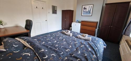a bedroom with a bed with two stuffed animals on it at Springvale house in Walkley
