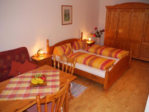 a bedroom with a bed and a table with bananas on it at Gaestehaus Hofer in Bad Birnbach