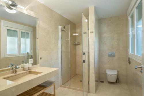 a bathroom with a shower and a sink and a toilet at Villa Jazmin in Mijas Costa