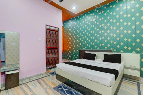 1 dormitorio con 1 cama en una habitación con pared en OYO C.M Paradise, en Lucknow
