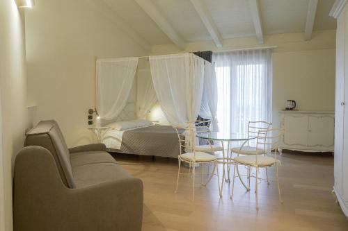 a living room with a bed and a table and chairs at Terra di Vento in Montecorvino Pugliano