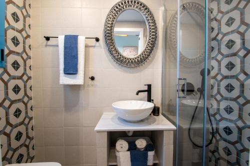 a bathroom with a sink and a mirror at Koskinou Traditional Houses in Koskinou